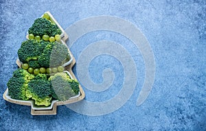 Creative edible Christmas tree made of fresh broccoli.Holiday ideas. New year food background top view . holiday, celebration,