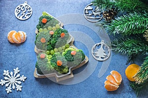 Creative edible Christmas tree made of fresh broccoli.Holiday ideas. New year food background top view . holiday, celebration,