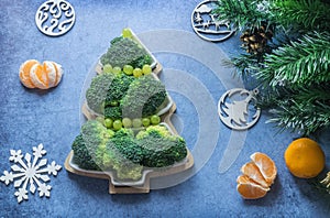 Creative edible Christmas tree made of fresh broccoli.Holiday ideas. New year food background top view . holiday, celebration,