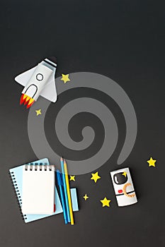 Creative education background. Back to school concept. Rocket astronaut cut from paper toilet roll tube and school tools set on