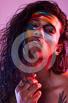 Creative, face paint and art with portrait of man in studio for beauty, self love and designer. Fantasy, neon and light