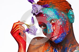 Creative fantastic makeup using colorful paints on the model