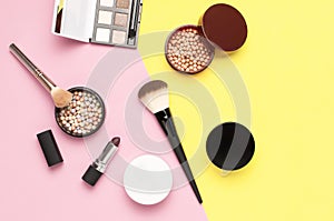 Creative Fashion background. Set of decorative cosmetics mascara powder lipstick eyeshadow blush makeup brush on colorful