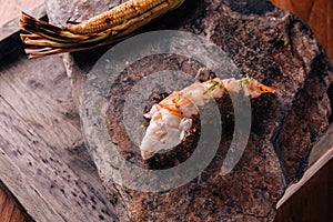 Creative Fine Dining: Grilled lobster and grilled corn served in natural stone form plate