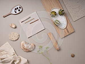 Creative flat lay composition with textile and paint samples, panels and cement tiles. Stylish interior designer moodboard. Light