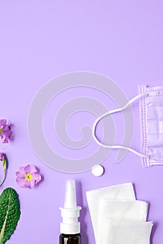 Creative flat lay concept of seasonal spring and summer pollen allergy with napkins, pills, face mask, drops