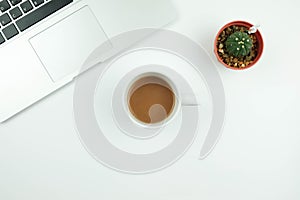 Creative flat lay design of workspace desk with laptop, cactus a