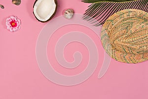 Creative Flat lay fashion style with coconut, seashells, palm leaves and panama hat