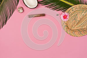 Creative Flat lay fashion style with hat, coconut, palm leaves and seashells on pastel color