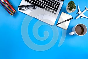 Creative flat lay photo of modern workplace with laptop, top view laptop background and copy space on blue background  background