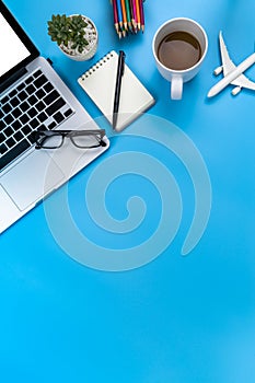 Creative flat lay photo of modern workplace with laptop, top view laptop background and copy space on blue background  background