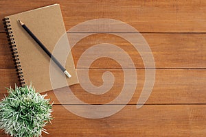 Creative flat lay photo of workspace desk. Office desk wooden table background with mock up notebooks and pencil and plant.