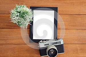 Creative flat lay photo of workspace desk. Office desk wooden table with old camera and poster mockup template.