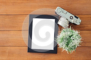 Creative flat lay photo of workspace desk. Office desk wooden table with old camera and poster mockup template.