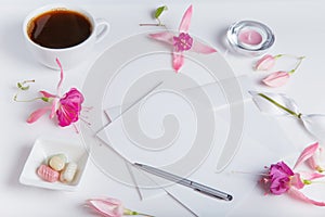 Creative flat lay photo of workspace desk with smartphone, coffee, pencil, flowers with copy space background. Flat lay