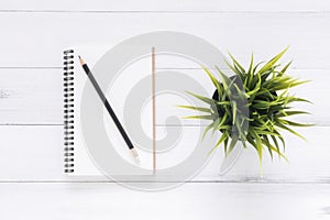 Creative flat lay photo of workspace desk. White office desk wooden table background with mock up notebooks and pencil and plant.