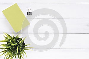 Creative flat lay photo of workspace desk. White office desk wooden table background with mock up notebooks and plant.