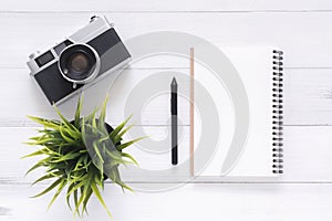 Creative flat lay photo of workspace desk. White office desk wooden table background with mock up notebooks and retro camera.