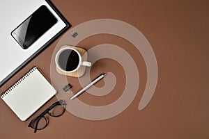 Creative flat lay, top view office table desk. Workspace with blank clip board, office supplies, pen, notepad, smartphone, glasses