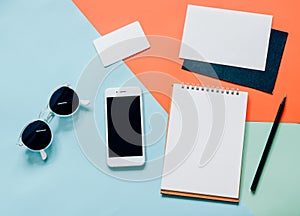 Creative flat lay of workspace desk with smartphone