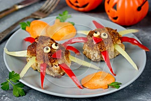 Creative food idea for kids - meatballs with colorful bell pepper shaped funny spider garnish pumpkin slice
