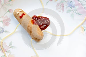 Creative food. killed sausage with ketchup