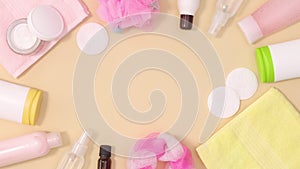 Creative frame made of skin care wellness and spa beauty products move on beige background with copy space. Stop motion flat lay