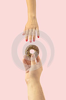 Creative funny concept of a delicious donut proposal on pastel pink background. Sweet love for life