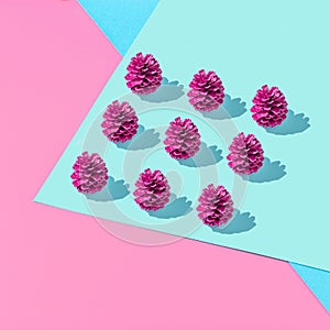 Creative geometric composition with colorful cones on vivid pink and blue background. Autumn fun concept