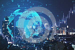 Creative globe hologram with money signs and candlestick graph on blurry night city backdrop. Global trade, finance, currency and
