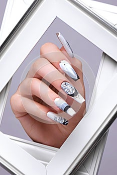 Creative gradient design of nails on female hands. Art manicure.