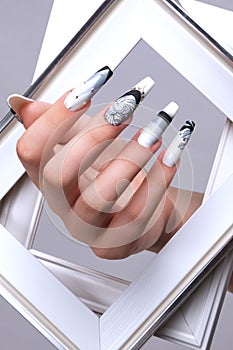 Creative gradient design of nails on female hands. Art manicure.