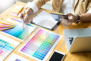 Creative Graphic designer at work. Color swatch samples pantone palette in studio modern office, interior design, renovation and