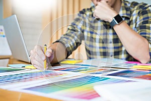 Creative Graphic designer at work. Color swatch samples pantone palette in studio modern office, interior design, renovation and