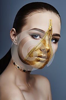 Creative grim makeup face of girl Golden color zipper clothing on skin. Fashion beauty creative cosmetics and skin care halloween