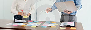 Creative group of business people brainstorming use sticky notes picking to share idea on table decision Choosing Concept for