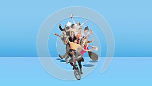 Creative group. Team, employees riding bike together over blue background. Ideas, brainstorming, imagination. Stop