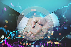 creative handshake and forex chart on bokeh night city backdrop. Financial growth and partnership concept. Double exposure