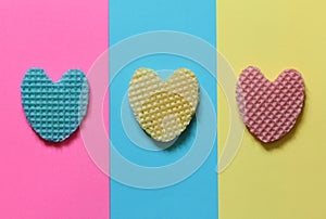 Creative heart from an edible wafer in pastel pink, blue, yellow