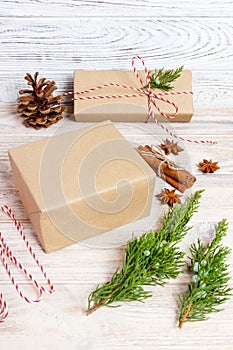 Creative hobby. Gift wrapping. Packaging modern christmas present boxes in stylish gray paper with satin red ribbon. Top