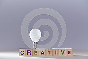 Creative idea generation. Innovation and creativity. Insight and originative thinking. Wooden cubes, lightbulb on top