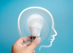 Creative idea, innovation, knowledge, idea and inspiration concept. Glowing bright white creative light bulb, holding by hand,