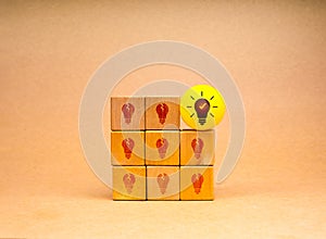 Creative idea and innovation, unique, insight, different, leadership, solutions and motivation concepts. Yellow light bulb icon on