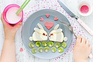 Creative idea for kid breakfast - cheese sandwich shaped cute white bunnies couple