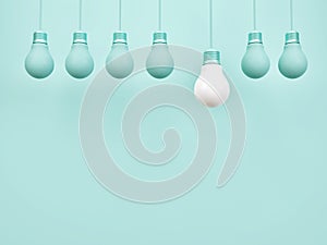 Creative idea light bulb symbol on simple pastel blue background with different idea design concept.