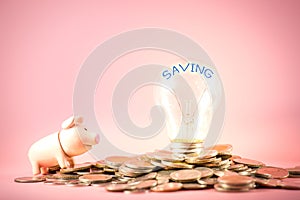 Creative ideas of saving money concept with lightbulb and piggy bank on coins pile. Business planning to the future