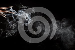 Creative illustration of incense stick aroma with smoke isolated on black background