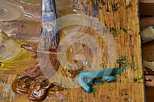 Creative image, artist`s palette with oil paints and brushes, close-up