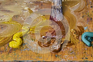 Creative image, artist`s palette with oil paints and brushes, close-up