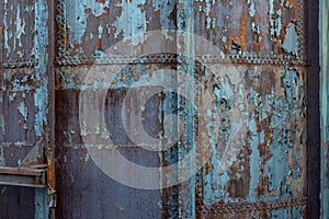 Creative industrial background with rusty metal, rivets, and peeling paint patinas
